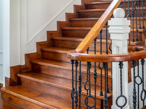 Classic vintage staircase in contemporary house Classic vintage elegant wooden staircase with wrought iron railing. house railing stock pictures, royalty-free photos & images