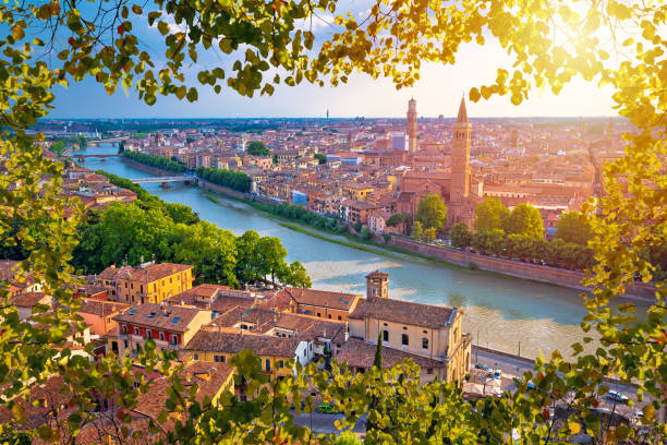 ciy of verona and adige river aerial view through leaf frame, tourist destination in veneto region of italy - veneto imagens e fotografias de stock