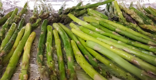istock Cooking delicious green grilled asparagus inside a foil 1047950506