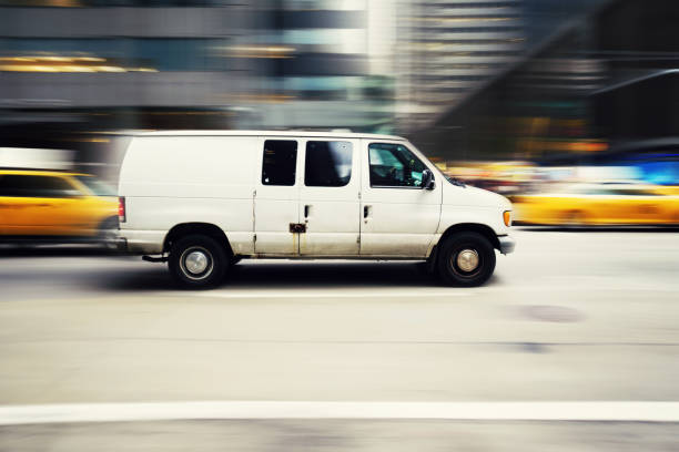 istock Commercial white van speeding in New York 1047951074