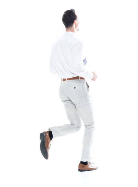 istock Handsome businessman running, rear view 1047951310