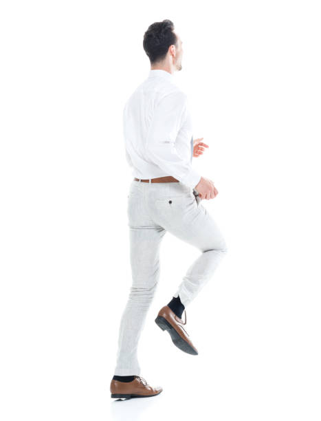 istock Handsome businessman running, rear view 1047951332