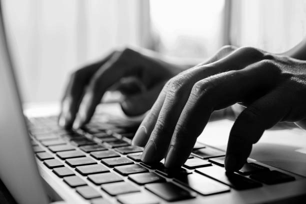 istock Black and white colour.Close up fingers typing on the computer keyboard,pressing buttons, typing, 1047951828