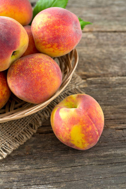 istock ripe peaches on wooden surface 1047961010