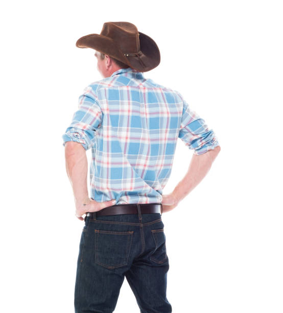 istock Handsome cowboy is standing with hands on hips 1047961152