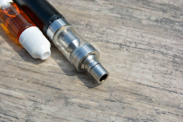 istock E - cigarette for vaping , technical devices.The liquid in the bottle 1047961600