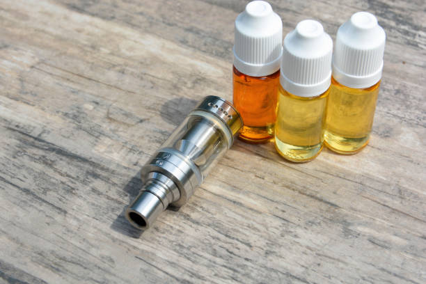 istock E - cigarette for vaping , technical devices.The liquid in the bottle 1047961668