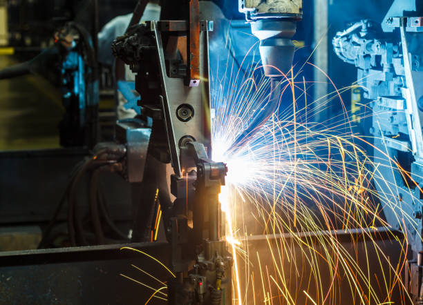 istock Robots welding in a car factory 1047964824