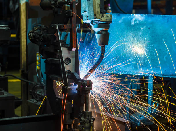 istock Robots welding in a car factory 1047965040