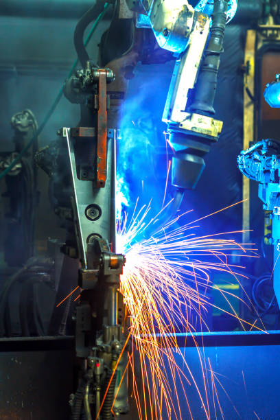 istock Robots welding in a car factory 1047965834