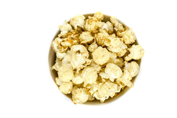 istock Top view of caramel popcorn in cup on white background 1047965852