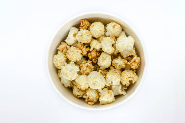 istock Top view of caramel popcorn in cup on white background 1047965856