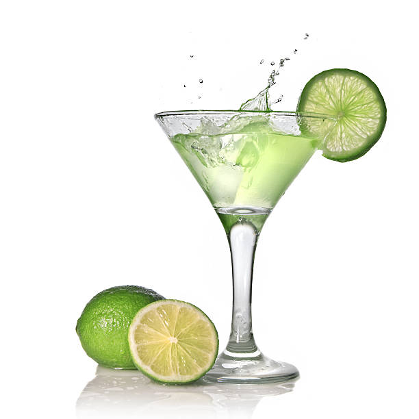 istock Green alchohol cocktail with lime and splash on white 104797064