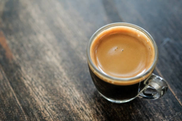 istock hot coffee on table wood 1047970702