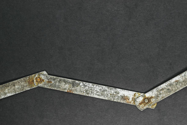 istock Old, rusty metal ruler on black background surface with free space 1047973430