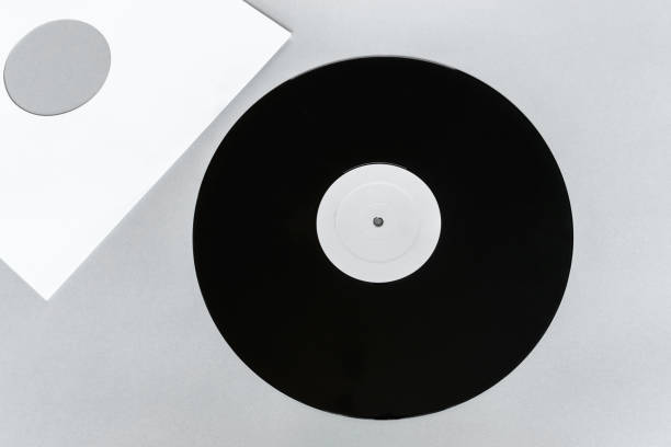 istock Vinyl LP on gray background surface with copy free space and white envelope near it 1047973582