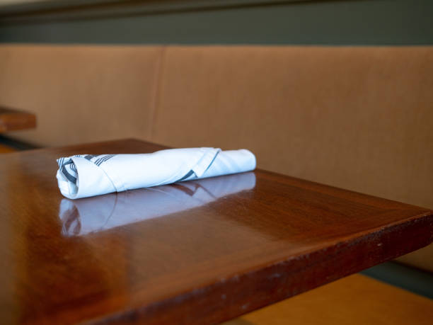 istock Napkin with utensils inside sitting on restaurant table, prepared for serving 1047974588