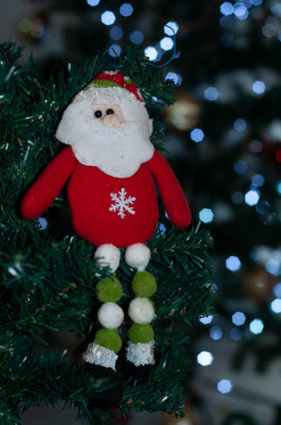 istock santa claus and christmas tree lit with christmas lights 1047985698