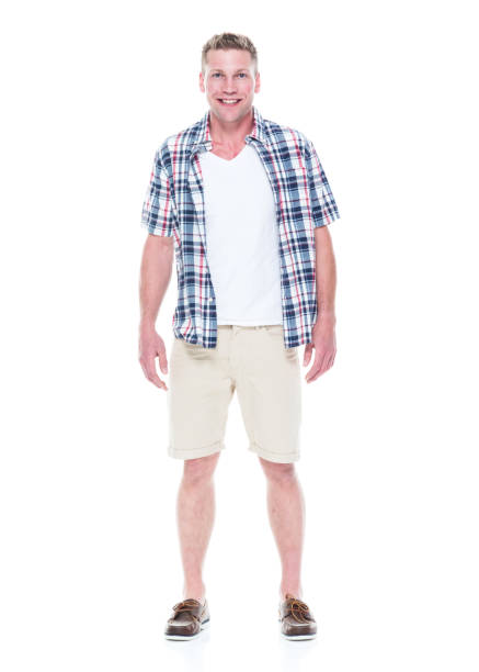 istock Handsome man in shirt and shorts with hands by side 1047994170