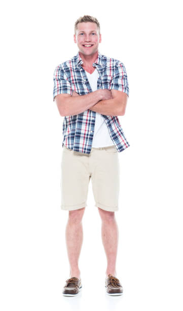istock Handsome man in shirt and shorts with arms folded 1047994270