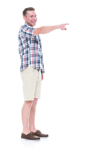 istock Handsome man in shirt and shorts pointing forward 1047994478