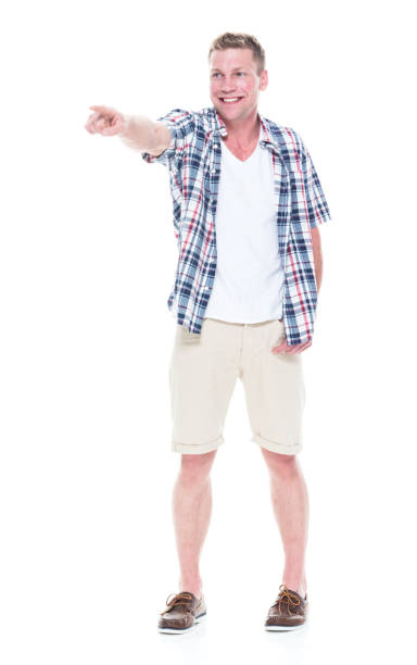istock Handsome man in shirt and shorts pointing forward 1047994576