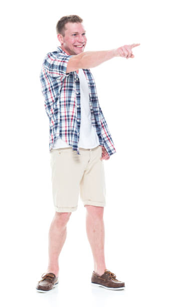 istock Handsome man in shirt and shorts pointing forward 1047994580