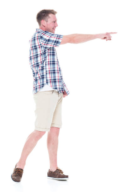 istock Handsome man in shirt and shorts pointing forward 1047994588