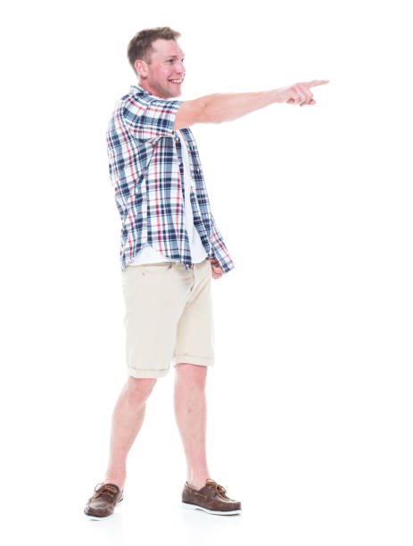 istock Handsome man in shirt and shorts pointing forward 1047994618