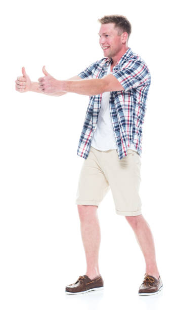 istock Handsome man in shirt and shorts is doing a double thumbs up 1047994694
