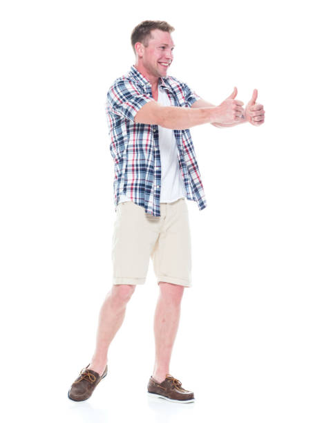 istock Handsome man in shirt and shorts is doing a double thumbs up 1047994708