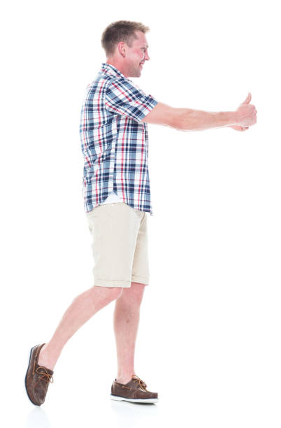 istock Handsome man in shirt and shorts is doing a double thumbs up 1047994766