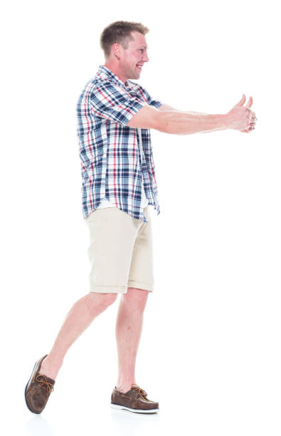 istock Handsome man in shirt and shorts is doing a double thumbs up 1047994770