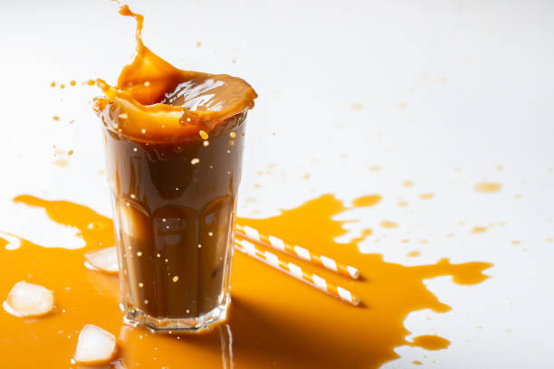 istock Iced latte coffee splash with ice cubes and roasted beans on a white background. With copy space 1048000176