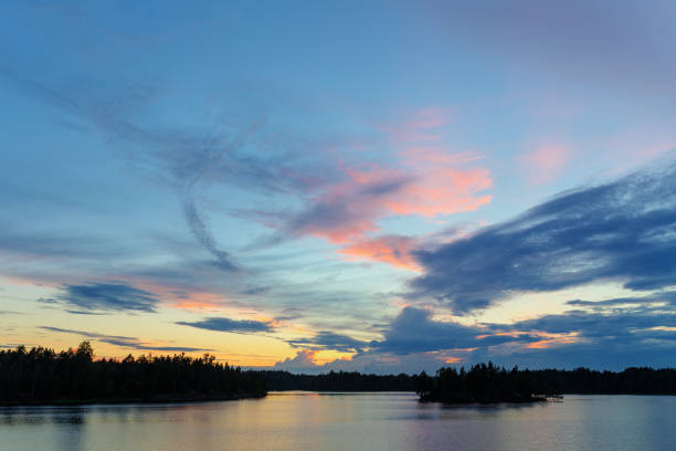 istock sunset with clouds over the forest lake 1048000452
