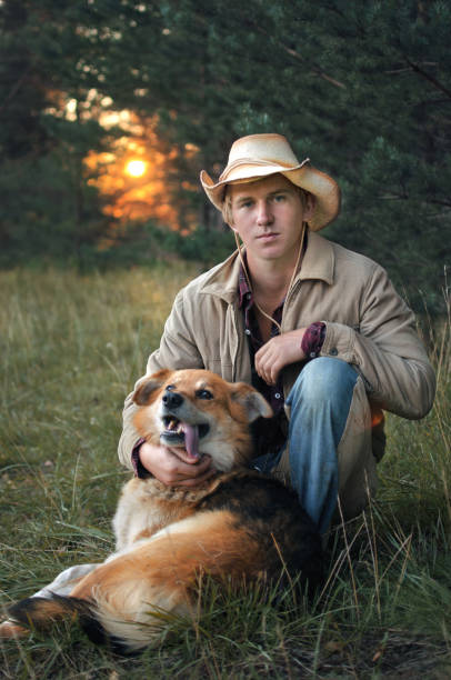istock young cowboy man and his dog 1048006378