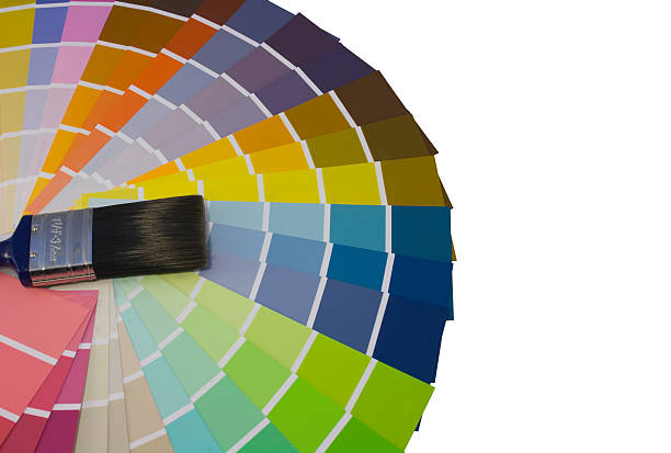 Fan of colour swatches and paint brush stock photo