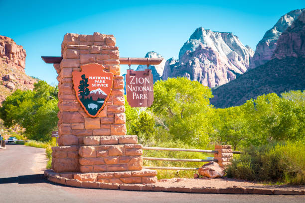 Zion National Park entrance sign, Utah, USA Zion National Park entrance monument sign on a beautiful sunny day with blue sky in summer, Utah, USA entrance sign photos stock pictures, royalty-free photos & images
