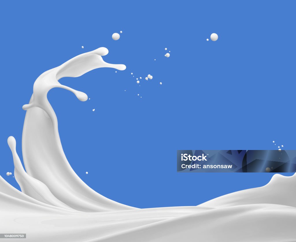 splashing milk milk splash against blue background Milk Stock Photo