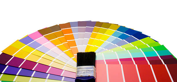 Fan of paint colour swatches and brush stock photo
