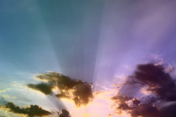 istock pretty bright sunset or sunrise partially cloudy sky with rainbow for using in design as background. 1048028846