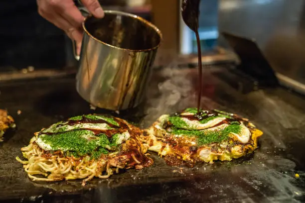 Photo of okonomiyaki is almost done on the iron plate