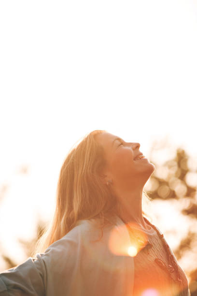 istock Woman with eyes closed enjoying sunny day 1048047304
