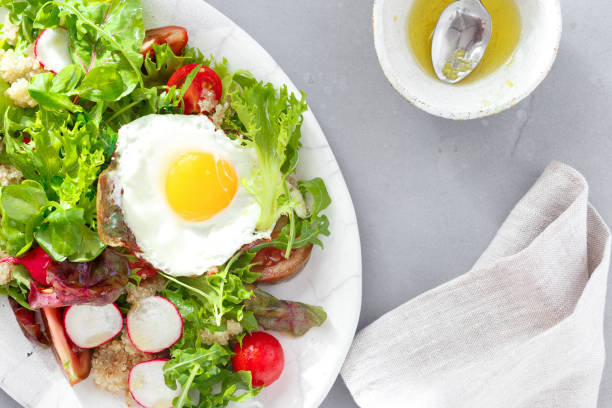 istock healthy breakfast summer salad fried egg gray concrete background top view 1048049988