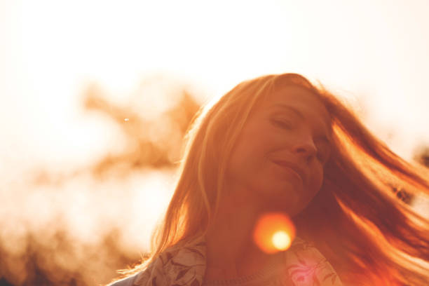 istock Woman with eyes closed enjoying sunny day 1048050110