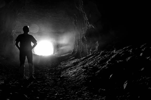istock Silhouette of a man in a cave 1048050512