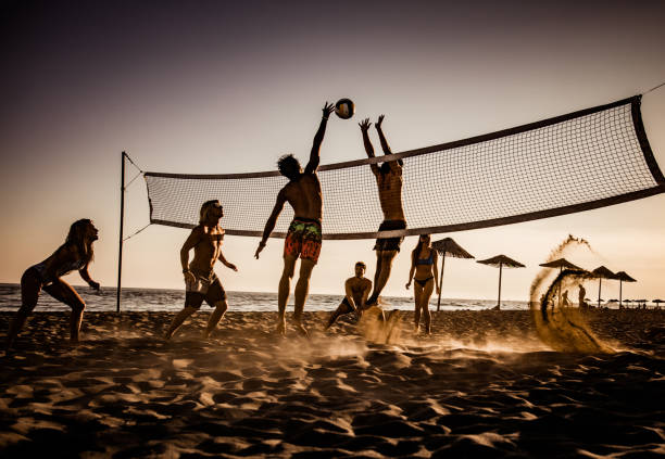 istock Young friends having fun while playing volleyball on the beach. 1048056144