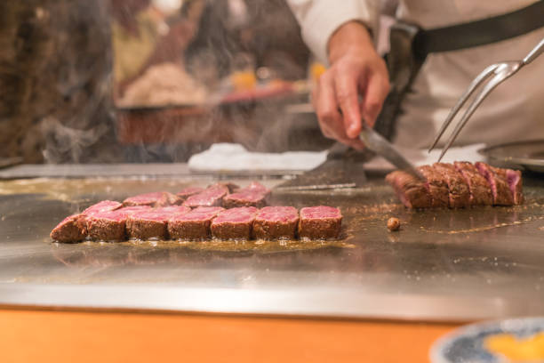 istock Chef use knife and fork to cook Japanese Kobe beef 1048059778