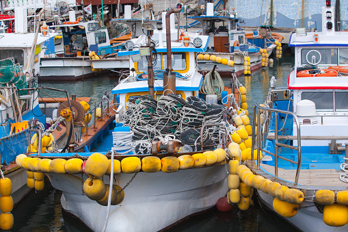 Fishing boats with yellow floats moored in port of Busan, South Korea