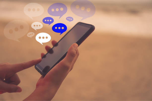istock Women hand using smartphone typing, chatting conversation in chat box icons pop up. Social media maketing technology concept.Vintage soft color tone background. 1048060168